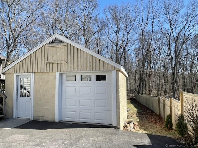 detached garage with driveway and fence