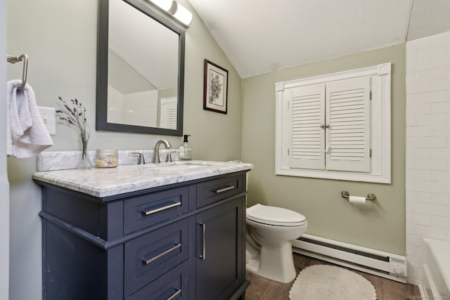 bathroom with a baseboard heating unit, lofted ceiling, vanity, and wood finished floors
