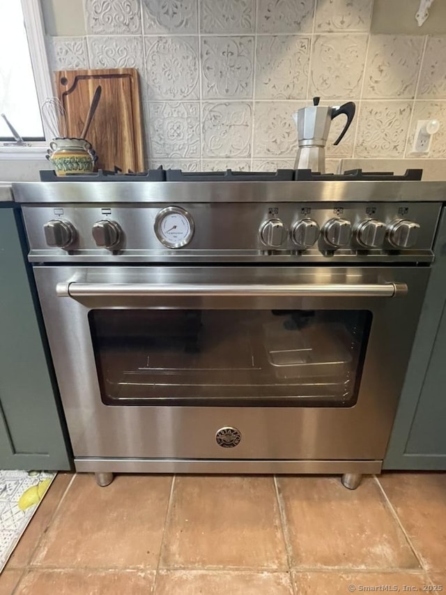 details featuring high end stainless steel range oven and backsplash