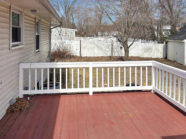 wooden deck with fence and an outbuilding