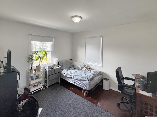 bedroom with dark wood-type flooring