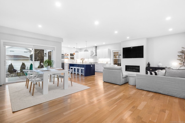 27 Hauser St, Milford, CT 06460 - living room with a glass covered fireplace, recessed lighting, and light wood-style floors