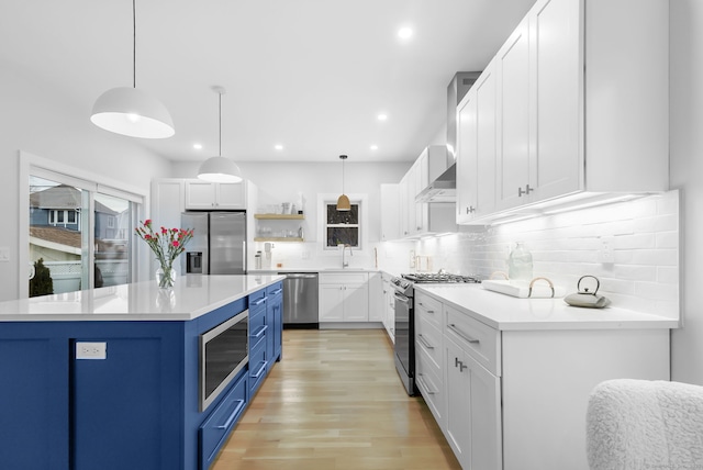 27 Hauser St, Milford, CT 06460 - kitchen with blue cabinets, light countertops, white cabinets, appliances with stainless steel finishes, and a sink