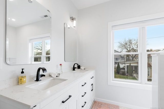 27 Hauser St, Milford, CT 06460 - full bath featuring baseboards, double vanity, a sink, and visible vents