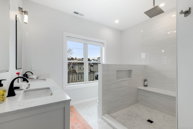 27 Hauser St, Milford, CT 06460 - bathroom with a tile shower, recessed lighting, a sink, double vanity, and baseboards