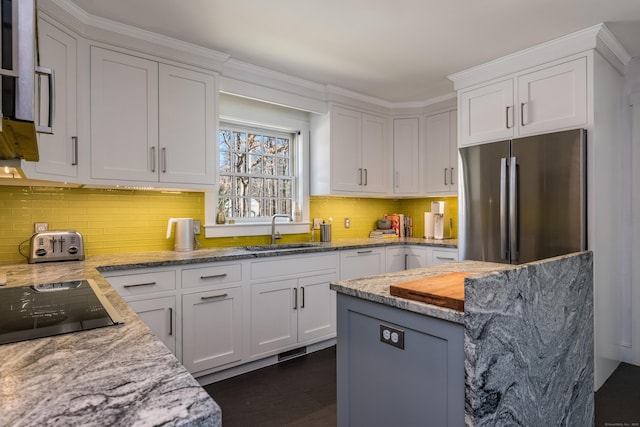 8 Shelter Rock Rd, East Haddam, CT 06423 - kitchen featuring a sink, freestanding refrigerator, white cabinetry, light stone countertops, and decorative backsplash