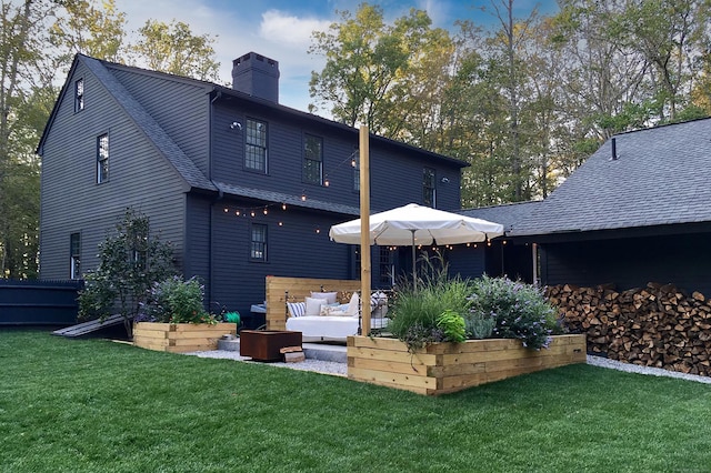 8 Shelter Rock Rd, East Haddam, CT 06423 - back of house featuring a chimney, an outdoor living space, a lawn, and a shingled roof