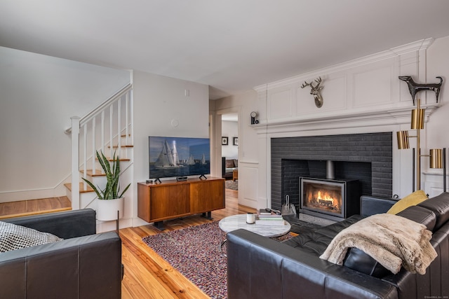 8 Shelter Rock Rd, East Haddam, CT 06423 - living area featuring wood finished floors, a brick fireplace, and stairs