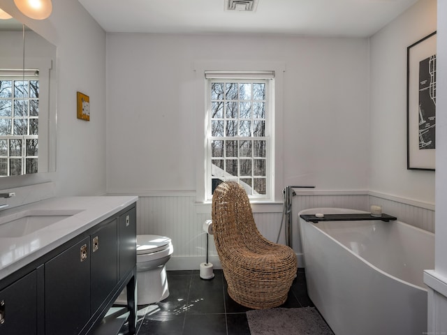 8 Shelter Rock Rd, East Haddam, CT 06423 - bathroom featuring wainscoting, tile patterned floors, a freestanding bath, vanity, and toilet