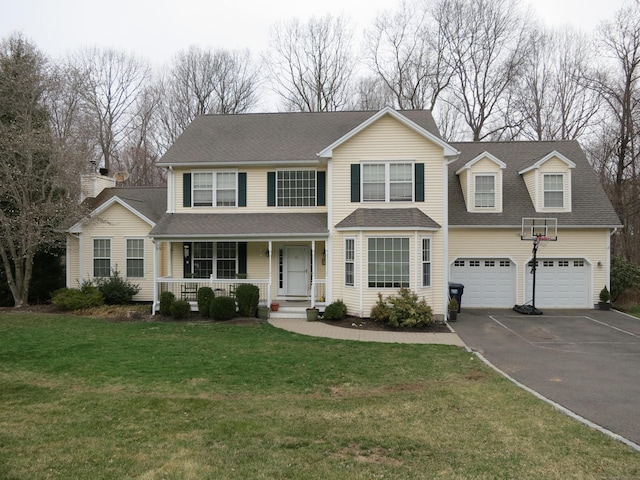 view of front of home with driveway, a garage, a front lawn, a shingled roof, and a porch
