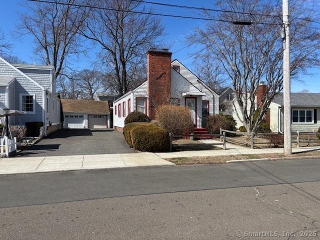 94 Morris St, West Haven, CT 06516 - view of front facade with a chimney and a garage