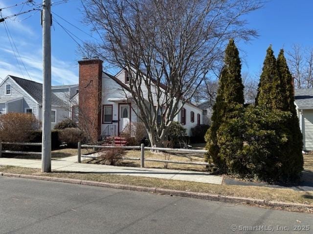 94 Morris St, West Haven, CT 06516 - view of front facade with a chimney and fence