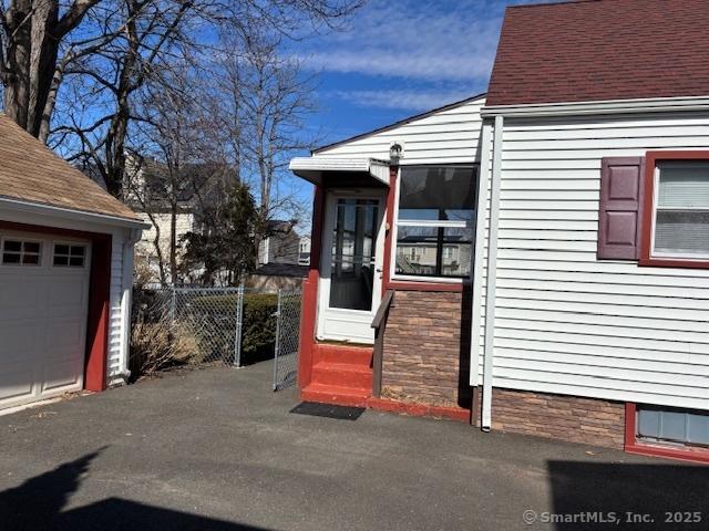 94 Morris St, West Haven, CT 06516 - view of exterior entry with fence and a garage