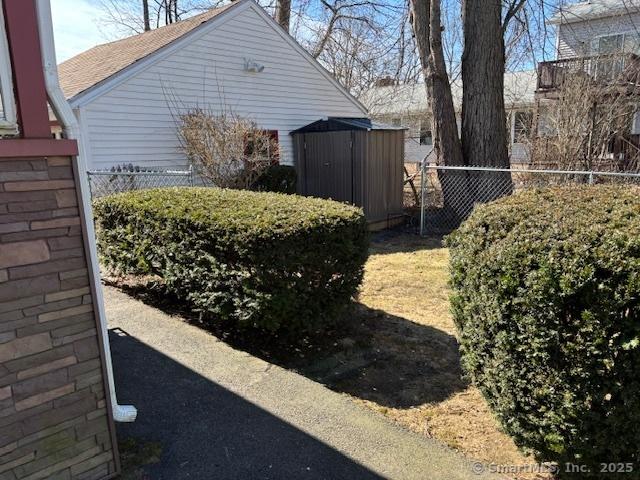 94 Morris St, West Haven, CT 06516 - view of side of property featuring fence, an outbuilding, and a shed