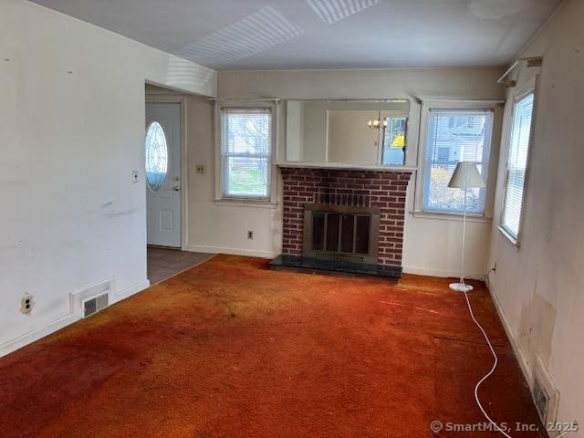 94 Morris St, West Haven, CT 06516 - unfurnished living room featuring a brick fireplace, carpet, a wealth of natural light, and visible vents