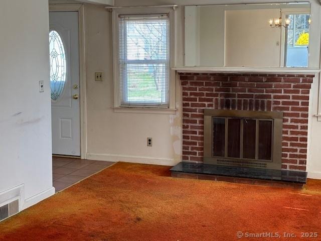 94 Morris St, West Haven, CT 06516 - unfurnished living room with visible vents, a brick fireplace, baseboards, and an inviting chandelier