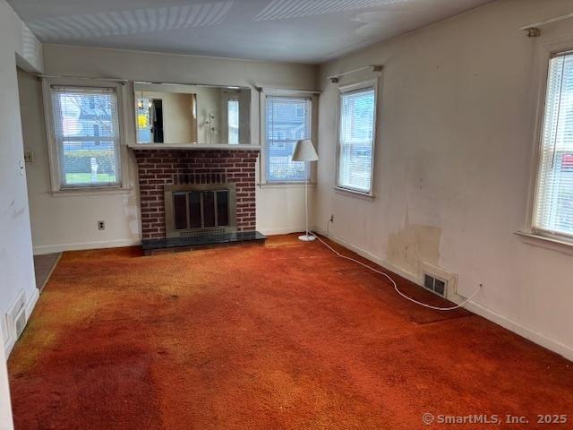 94 Morris St, West Haven, CT 06516 - unfurnished living room featuring plenty of natural light, baseboards, and carpet