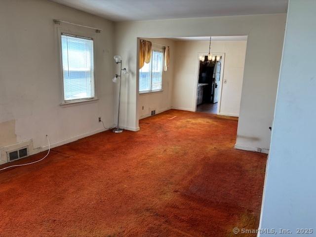 94 Morris St, West Haven, CT 06516 - unfurnished dining area with baseboards, an inviting chandelier, visible vents, and carpet