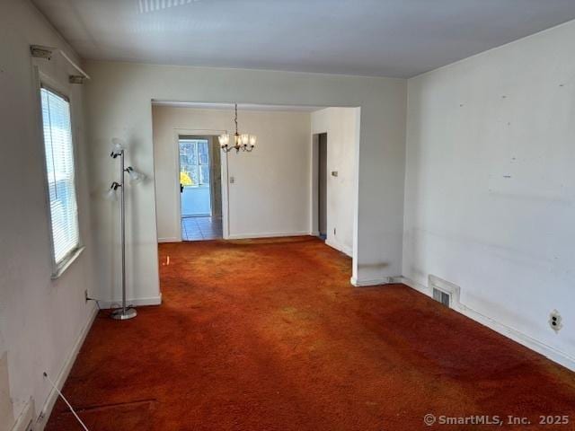 94 Morris St, West Haven, CT 06516 - unfurnished dining area featuring carpet floors, visible vents, baseboards, and a notable chandelier