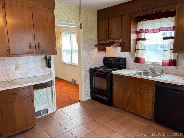 94 Morris St, West Haven, CT 06516 - kitchen featuring a sink, tasteful backsplash, light countertops, under cabinet range hood, and black appliances