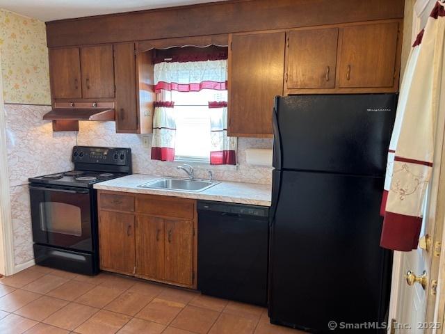 94 Morris St, West Haven, CT 06516 - kitchen with wallpapered walls, under cabinet range hood, light countertops, a sink, and black appliances