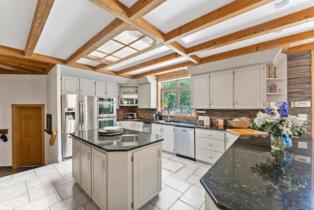 kitchen with white cabinets, stainless steel appliances, a sink, tasteful backsplash, and open shelves