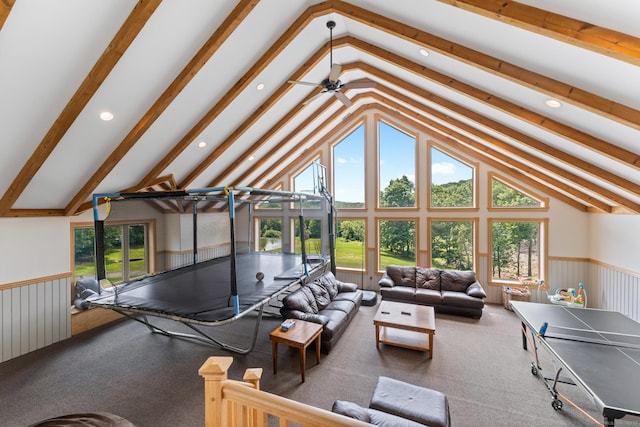 carpeted living area with recessed lighting, high vaulted ceiling, ceiling fan, and wainscoting