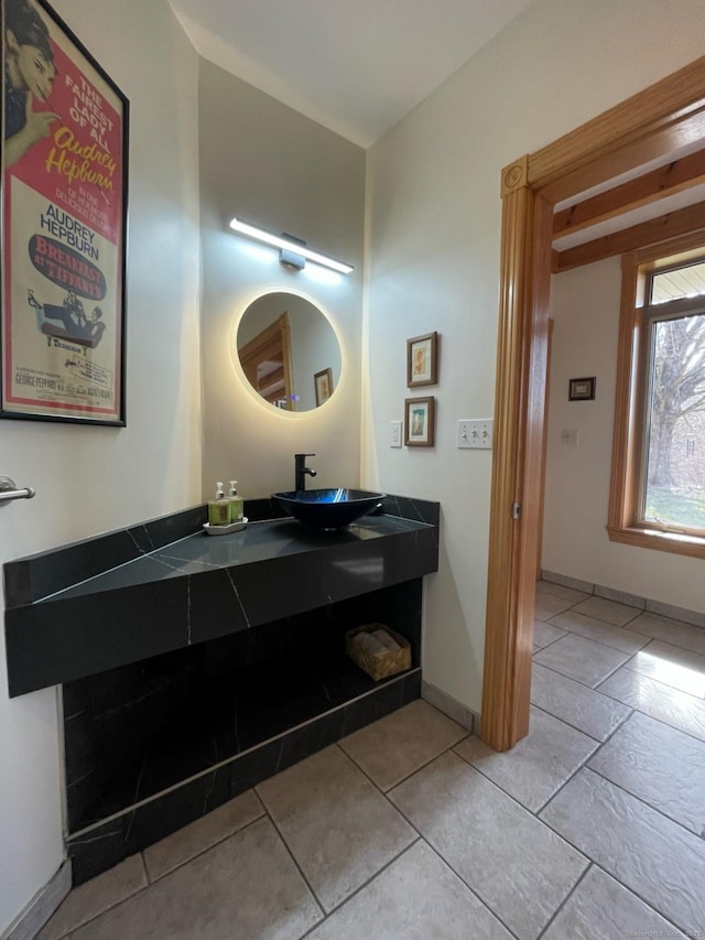 bathroom featuring baseboards and vanity
