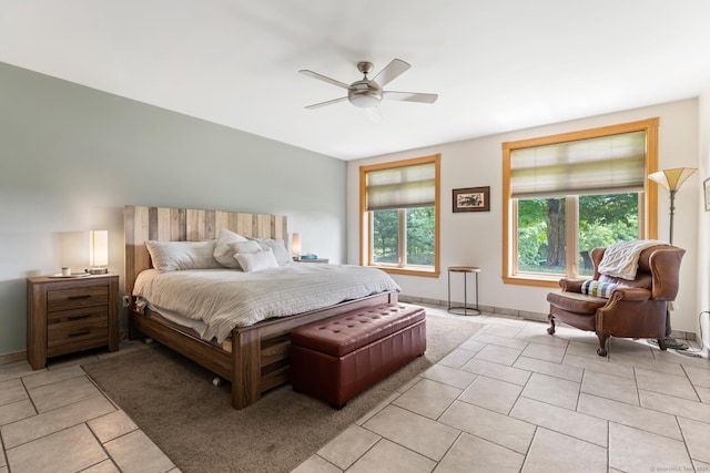 bedroom with ceiling fan and light tile patterned floors
