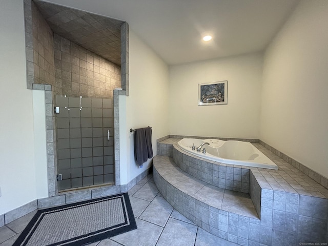 bathroom with recessed lighting, a shower stall, a garden tub, and tile patterned floors