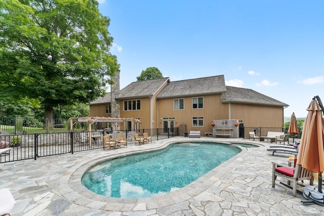 view of swimming pool featuring fence, a patio, a pool with connected hot tub, and a pergola