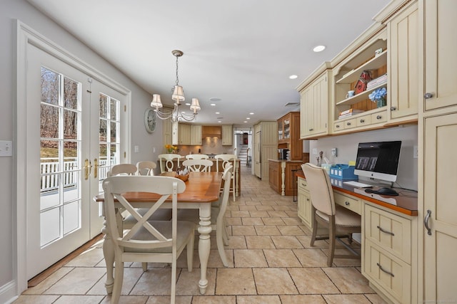 dining space featuring a chandelier, built in desk, plenty of natural light, and recessed lighting