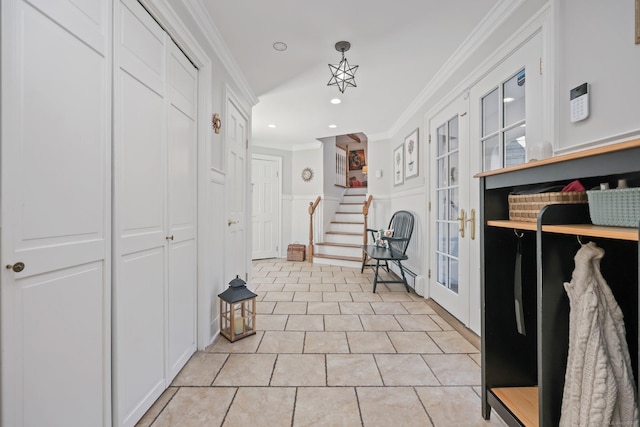 hallway featuring light tile patterned floors, a decorative wall, crown molding, recessed lighting, and stairway