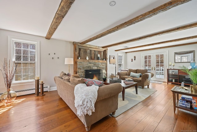 living room with hardwood / wood-style floors, a fireplace, beam ceiling, and a wealth of natural light