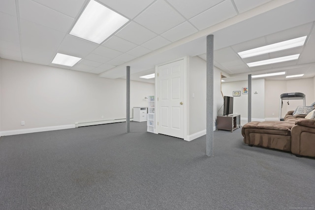 finished basement featuring baseboard heating, a paneled ceiling, carpet flooring, and baseboards