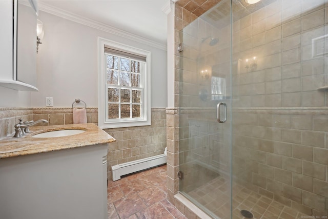bathroom with baseboard heating, tile walls, ornamental molding, and a stall shower
