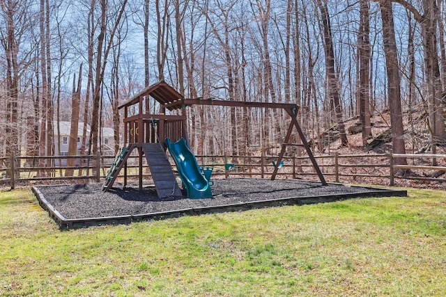 view of playground with fence and a lawn