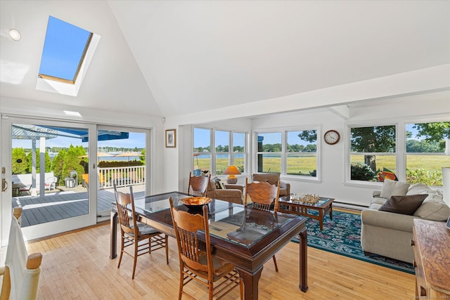 231 Pawson Rd, Branford, CT 06405 - dining area featuring plenty of natural light, high vaulted ceiling, light wood-style floors, a skylight, and a baseboard heating unit