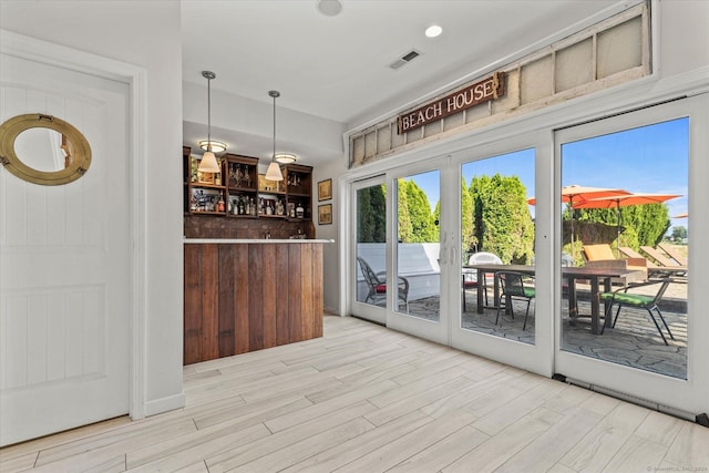 231 Pawson Rd, Branford, CT 06405 - doorway to outside featuring wood finished floors and a dry bar