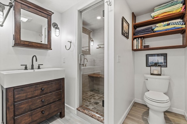 231 Pawson Rd, Branford, CT 06405 - bathroom featuring a stall shower, toilet, baseboards, wood finished floors, and vanity
