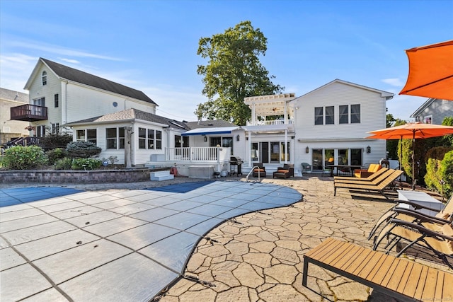 231 Pawson Rd, Branford, CT 06405 - rear view of property with a pergola, a covered pool, a patio, and an outdoor living space