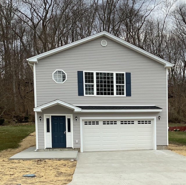 traditional-style home with an attached garage and concrete driveway