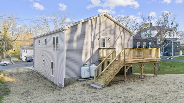 back of house featuring stairway and a deck