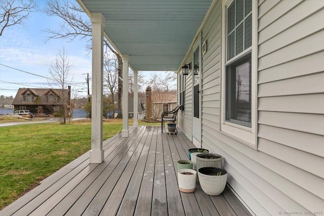 wooden deck featuring a yard
