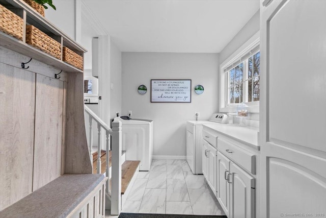 interior space with marble finish floor, baseboards, and washing machine and dryer