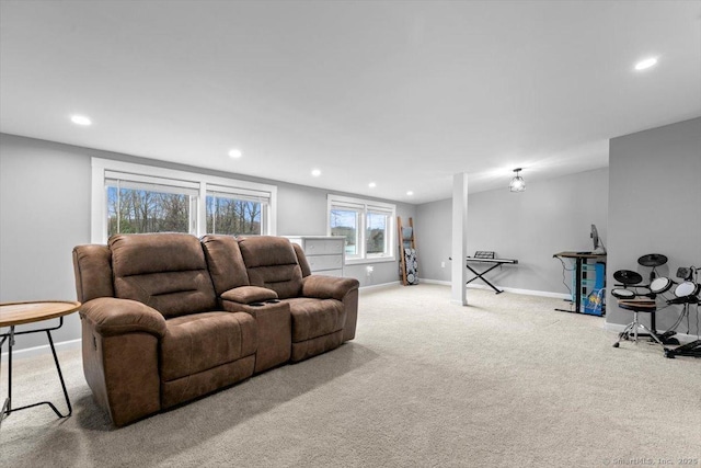 carpeted living area featuring baseboards and recessed lighting