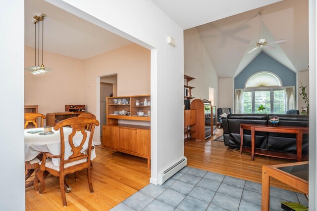 175 Thistle Pond Dr Unit 175, Bloomfield, CT 06002 - dining area with a baseboard radiator, a ceiling fan, light tile patterned flooring, and vaulted ceiling