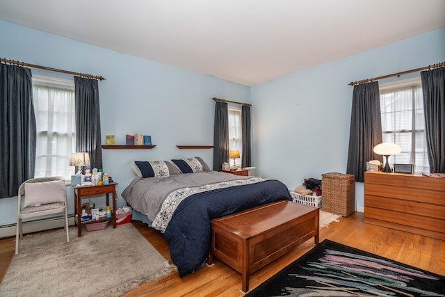 175 Thistle Pond Dr Unit 175, Bloomfield, CT 06002 - bedroom with multiple windows, light wood-style flooring, and a baseboard heating unit