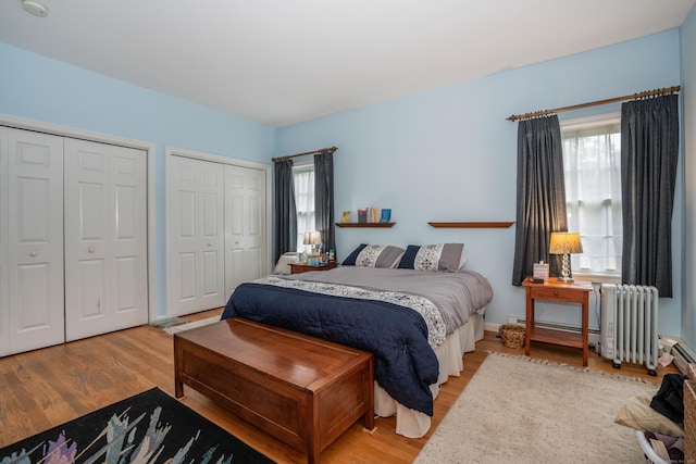 175 Thistle Pond Dr Unit 175, Bloomfield, CT 06002 - bedroom featuring radiator heating unit, two closets, and wood finished floors