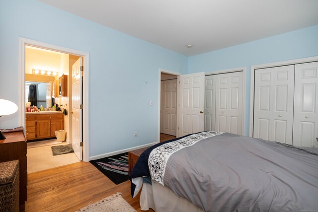 175 Thistle Pond Dr Unit 175, Bloomfield, CT 06002 - bedroom with multiple closets, light wood-style floors, ensuite bath, and a sink